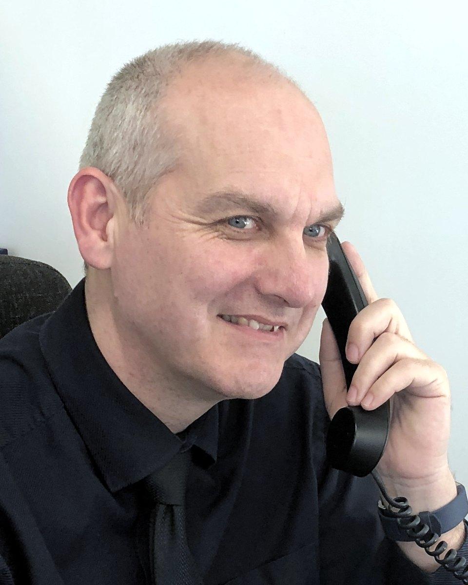 Robin Worden on the phone at his desk